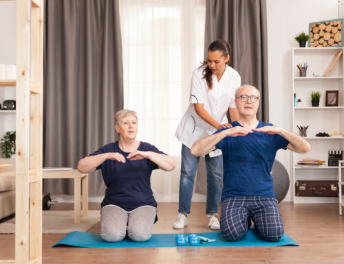 Senior couple doing physical therapy with doctor at home. Home assistance, physiotherapy, healthy lifestyle for old person, training and healthy lifestyle